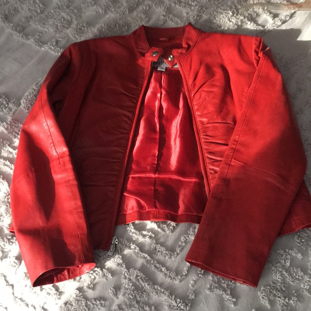 Like new, excellent condition red leather jacket with two way zipper.